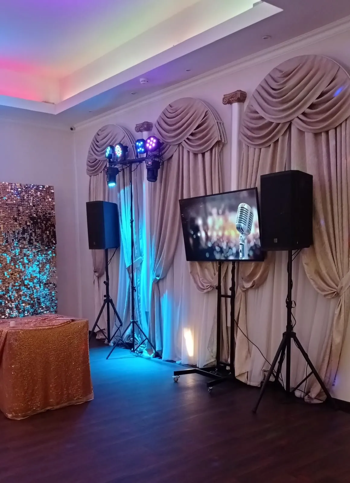 Karaoke setup with a large screen and microphones at a San Diego event