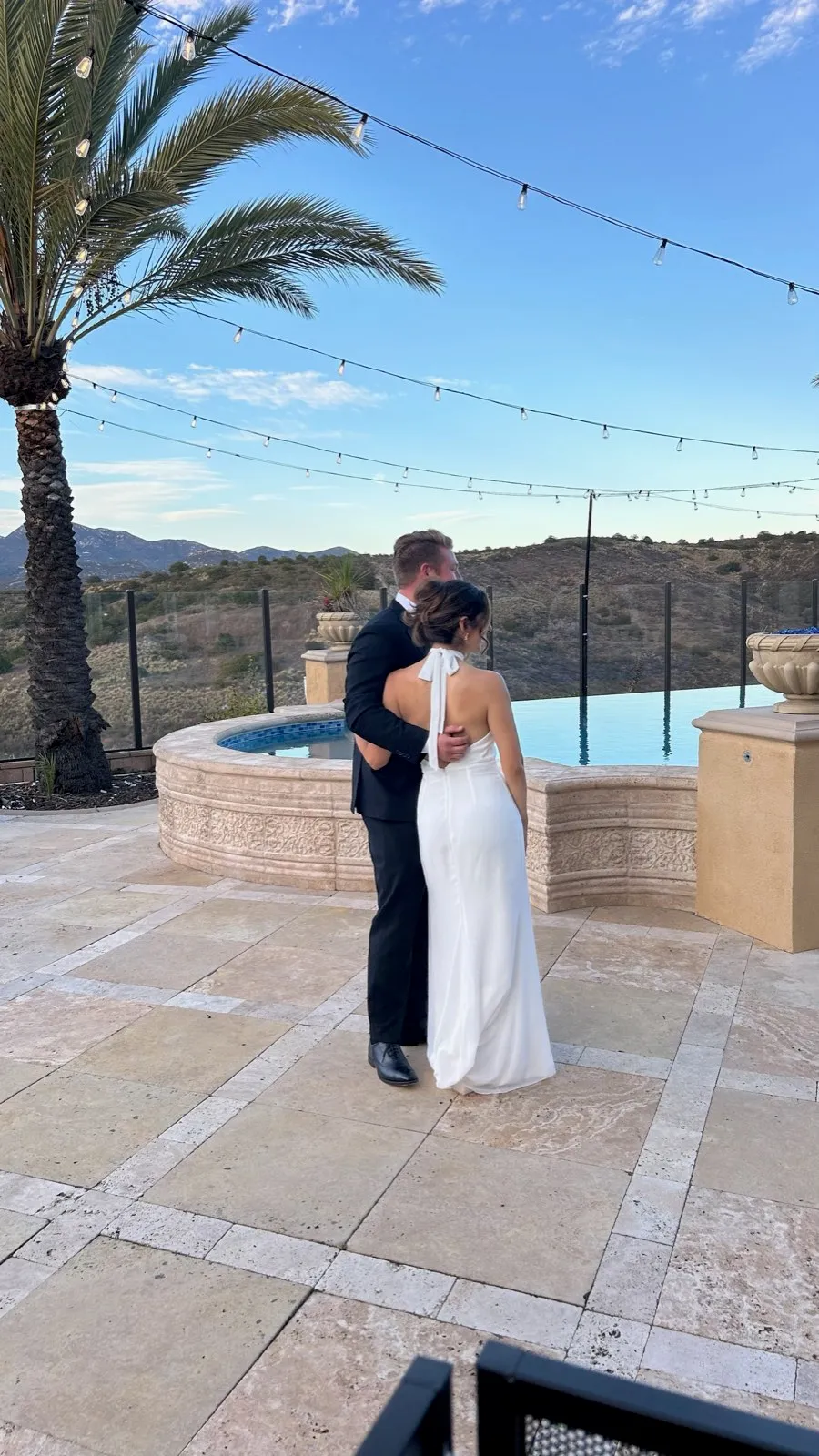 Bride and groom by the infinity pool at their Poway estate wedding