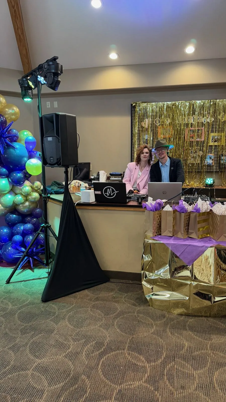 Rocket Karaoke's DJs at the booth beside a balloon arch at a 55th birthday party